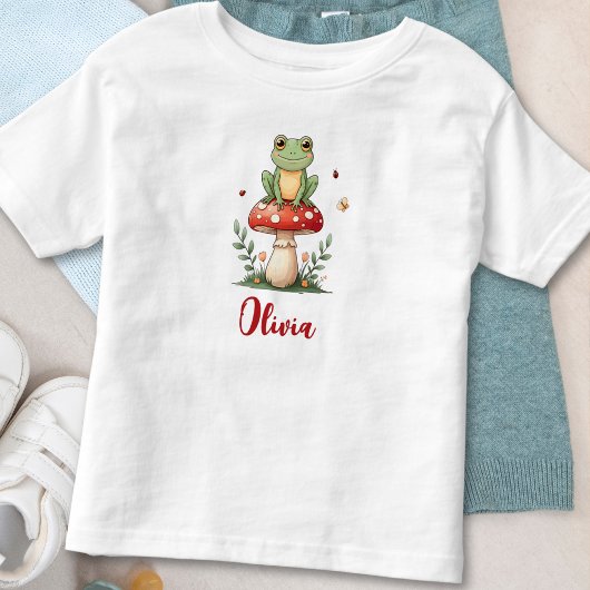 赤いキノコの上の可愛いカエル トドラーTシャツ