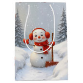 赤いシャベルのクリスマス雪だるま ミディアムペーパーバッグ (正面)
