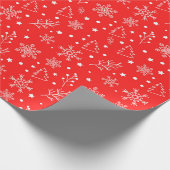 赤い背景に雪の結晶、星、植物の模様 ラッピングペーパー (角)