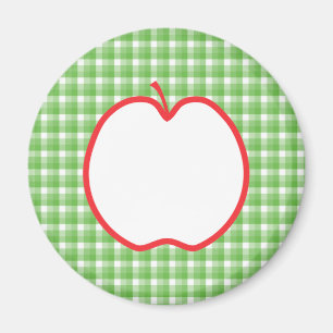 赤いApple。 緑および白い点検の背景を使って マグネット