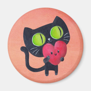 赤くかわいいハートを抱き締めているロマンチックな猫 マグネット