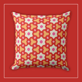 赤とピンクの幾何学的な花模様の背景に白い花 クッション