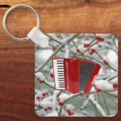 赤アコーディオン – 雪の背景の果実 キーホルダー (正面)