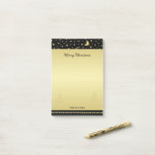 金ゴールドの光沢のあるクリスマススター、金ゴールドと黒の前足 ポストイット (デスク上)