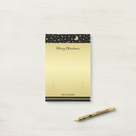 金ゴールドの光沢のあるクリスマススター、金ゴールドと黒の前足 ポストイット (デスク上)