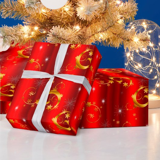 金ゴールドの渦巻き星と赤いクリスマス ラッピングペーパー