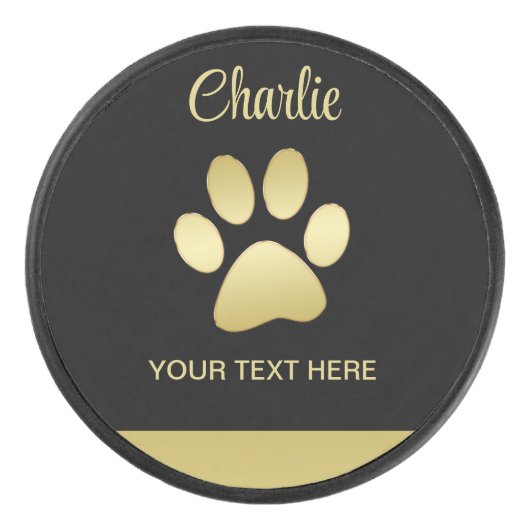 金ゴールドシャイニーな犬の手を黒い背景に アイスホッケーパック (正面)