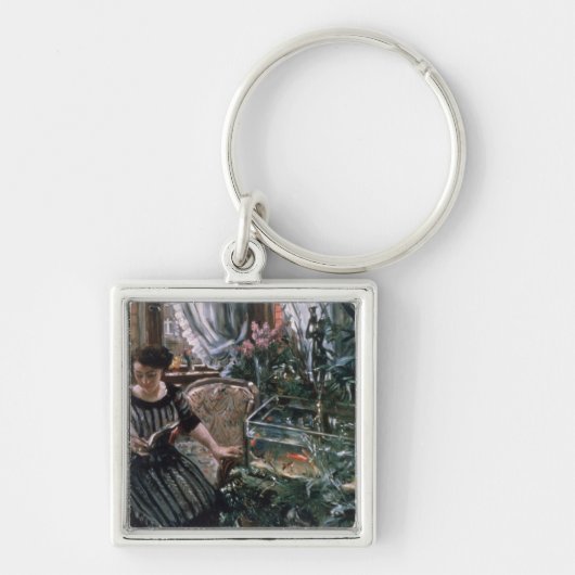 金魚タンクの近くで読んでいる女性 キーホルダー (正面)