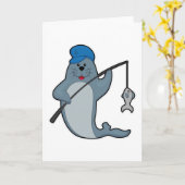 釣り竿と魚で釣りを楽しむアザラシ カード (黄色い花)