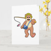 釣り竿を持って釣りをしているクマ カード (黄色い花)