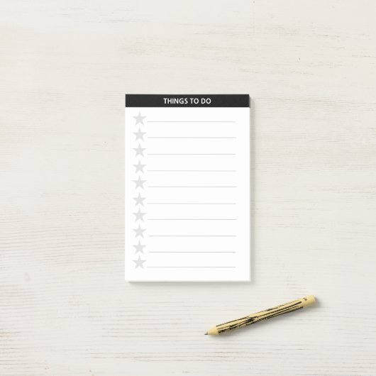 銀灰色の星と黒のヘッダーを行う ポストイット (デスク上)