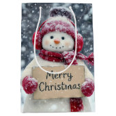 雪だるまがクリスマスにメリーサインを掲げる ミディアムペーパーバッグ (正面)