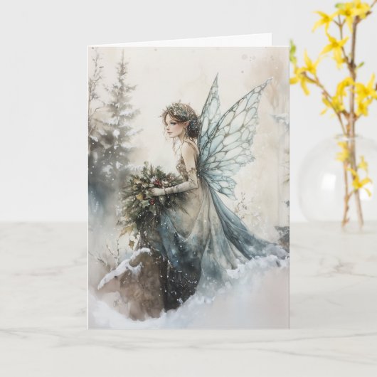 雪に花束を持つ水色のクリスマスフェアリー カード (黄色い花)