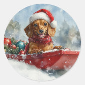 雪のクリスマスを許すそりにダックスシュント犬 ラウンドシール (正面)