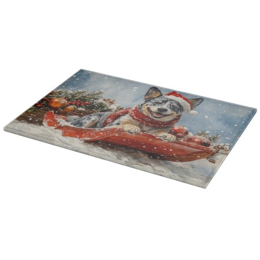 雪のクリスマスを許すそりの青いヒーラー犬 カッティングボード (角)