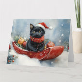 雪のクリスマスを過ごすソリの黒猫 カード (正面)