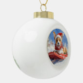 雪のクリスマスを過ごす大雪のバセンジ犬 セラミックボールオーナメント (左)