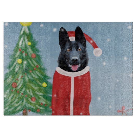 雪のクリスマスプレゼントに黒いドイツの羊飼い犬 カッティングボード (正面)