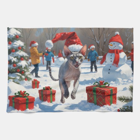 雪のクリスマス帽子を被ったスフィンクス猫が走る キッチンタオル (横)