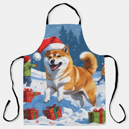 雪のクリスマス帽子を被った柴犬が走る エプロン (正面)