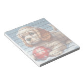 雪の上でボールで休むコッカースパニエル犬の子犬 ノートパッド (アングル)