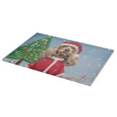 雪の中でコッカースパニエル犬の犬とクリスマスプレゼント カッティングボード (角)