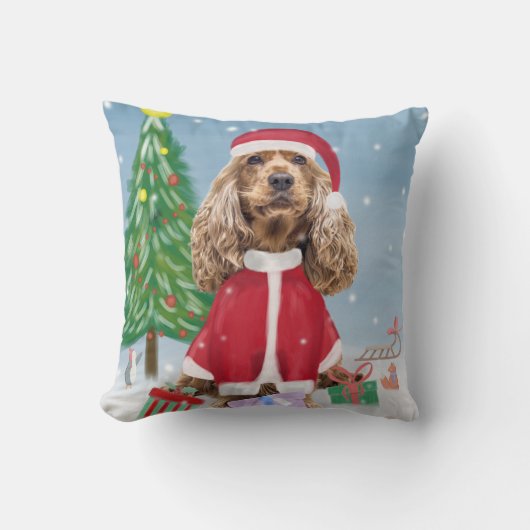 雪の中でコッカースパニエル犬の犬とクリスマスプレゼント クッション (正面)