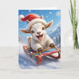 雪の中でソリ遊びをするクリスマスのヤギの面白いデザイン シーズンカード