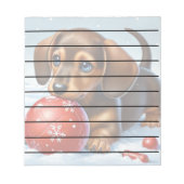 雪の中で愛らしいダッシ遊ャンドの子犬 ノートパッド (正面)