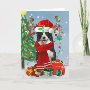 雪の中のクリスマスプレゼントを持つボーダーコリー犬 カード
