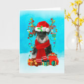 雪の中のシュナウザーとクリスマスプレゼント カード (黄色い花)