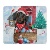 雪の中のダックスシュント犬の家 カッティングボード (正面)