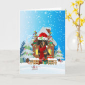 雪の中のダックスフンドとクリスマスプレゼント カード (黄色い花)