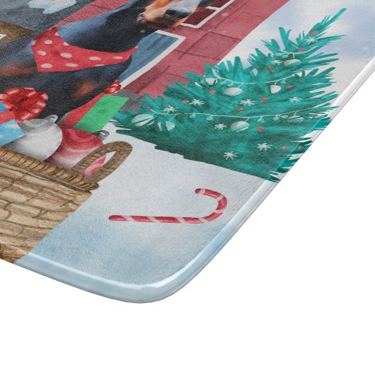 雪の中のドバーマンドッグのクリスマスドッグハウス カッティングボード (角)