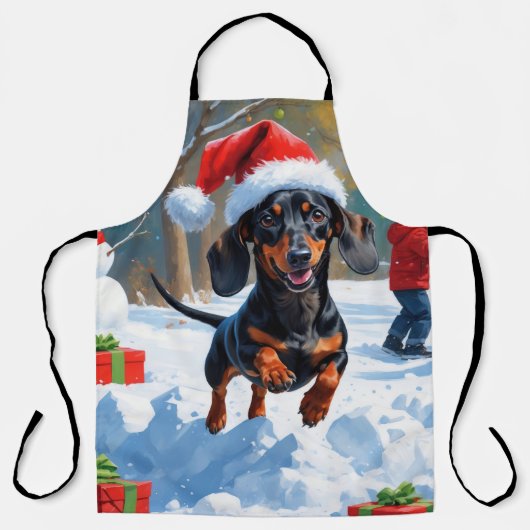雪の中を走るダックスフンドのクリスマス帽 エプロン (正面)