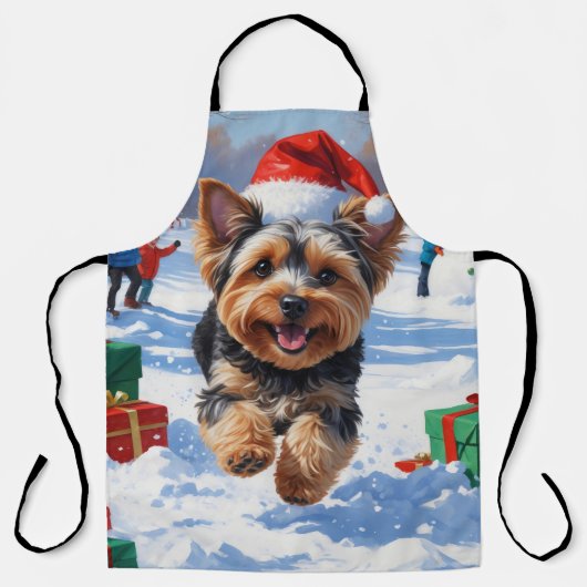 雪の中を走るヨーキープー(クリスマス帽子付き) エプロン (正面)