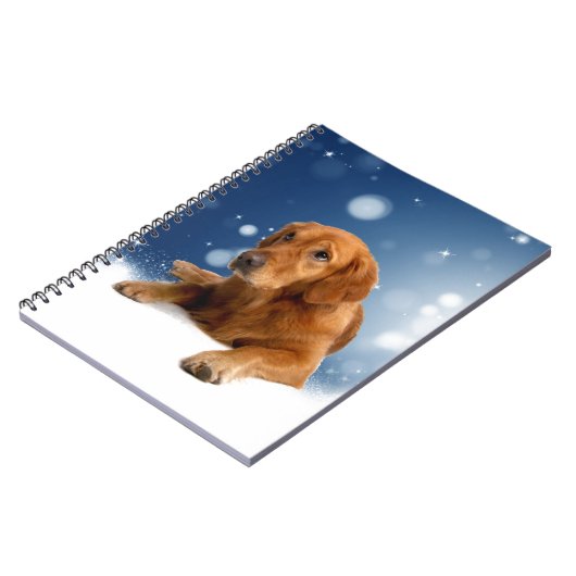 雪の星に座る、かわいいゴールデンレトリバー犬 ノートブック (左側)