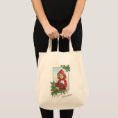 雪の玉を持つクリスマスの少女 トートバッグ (正面(商品))
