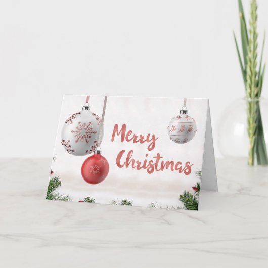 雪の降る聖降誕祭のお祝いの白と金のボール シーズンカード (正面)