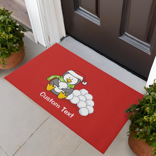 雪玉と座っているクリスマス ペンギン ドアマット
