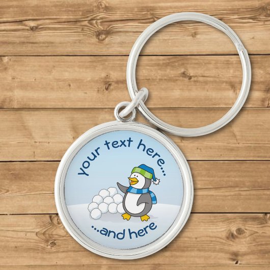 雪玉を振る小さなペンギン キーホルダー