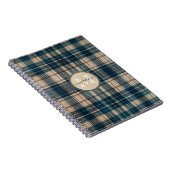 青いフランネルの背景のモノグラム ノートブック (右側)