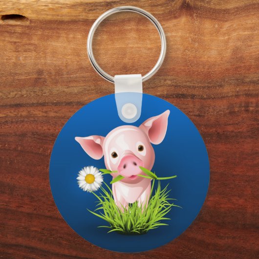 青い上に緑の草を植えた小さなピンクの豚 キーホルダー (正面)