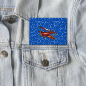 青い円とループの赤い飛行機 缶バッジ (インサイチュ)