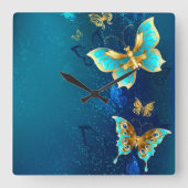 青い背景にチョウが黄金色に スクエア壁時計 (正面)