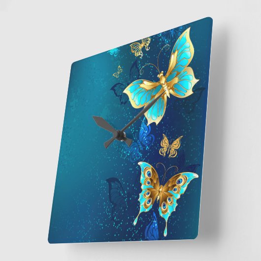 青い背景にチョウが黄金色に スクエア壁時計 (傾斜)