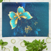 青い背景に浮かぶ金色の蝶 キッチンタオル (折り畳み)