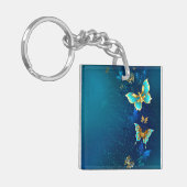 青い背景に浮かぶ金色の蝶 キーホルダー (正面左)