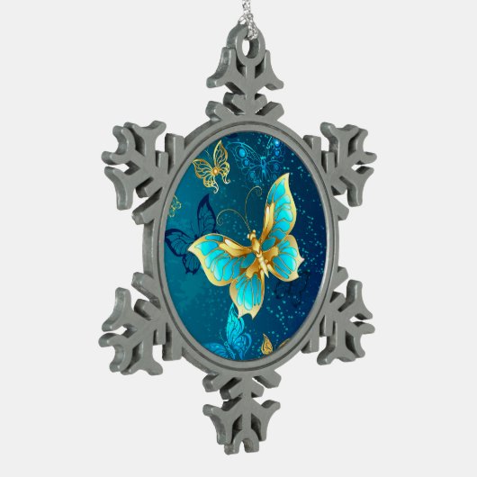 青い背景に浮かぶ金色の蝶 スノーフレークピューターオーナメント (左)