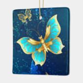 青い背景に浮かぶ金色の蝶 セラミックオーナメント (左)